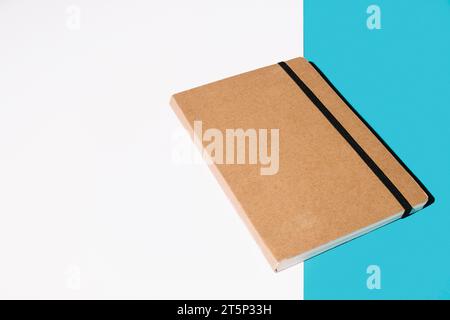 Brown cover notebook white blue background Stock Photo