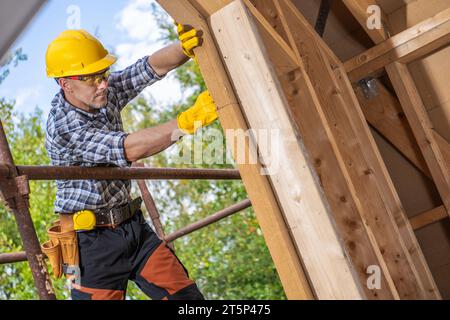 Contractor Worker Wearing Hard Hat and Safety Glasses Inside Construction Site Stock Photo