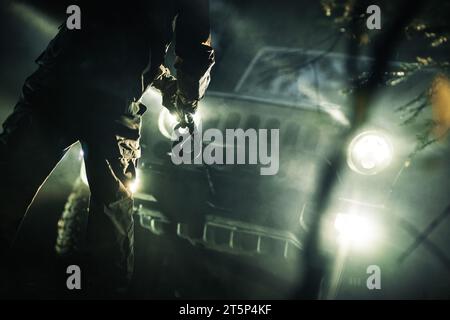 A Man with a Winch Rope in His Hand Preparing For a Four Wheels Drive Car Recovery Stock Photo