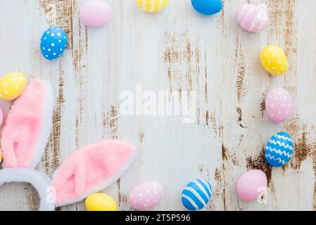 Many easter eggs with bunny ears wooden table Stock Photo