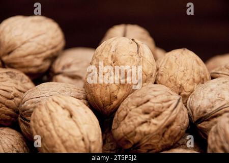 Walnuts on the table in a wicker basket. Stock Photo