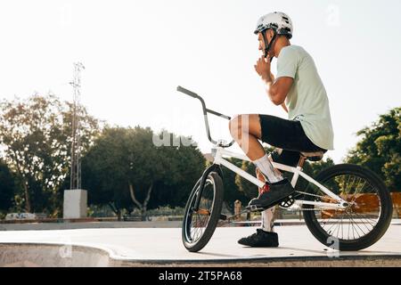 Young bmx rider looking away low angle shot Stock Photo