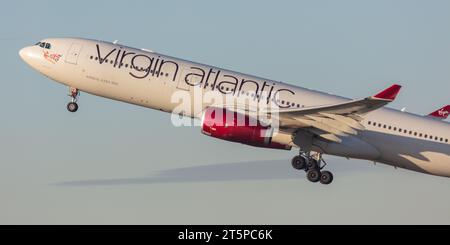 A Virgin Atlantic Airbus A330-343, registration G-VLUVH (Lady Love)  heading west out of Manchester Airport (MAN) on a sunny autumn evening Stock Photo