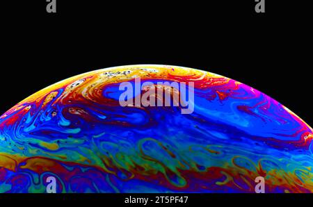 Colorful soap bubble on black background. Stock Photo