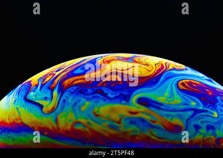 Colorful soap bubble on black background. Stock Photo