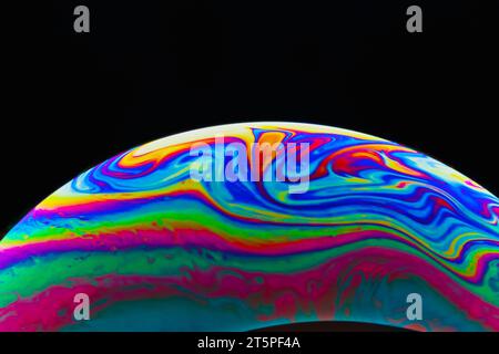 Colorful soap bubble on black background. Stock Photo