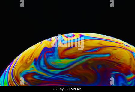 Colorful soap bubble on black background. Stock Photo
