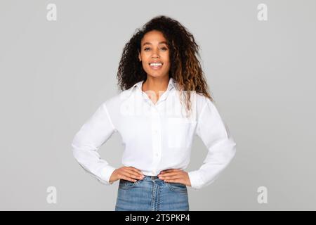 african lady holding hands on hips standing with confidence, studio Stock Photo