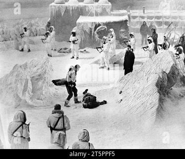 Patrick McGoohan (standing center), Ernest Borgnine (prone), Rock Hudson (standing, dark parka), on-set of the film, 'Ice Station Zebra', MGM, 1968 Stock Photo