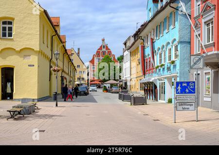 Lively everyday scene in front of a historic architectural backdrop in the Old Town of Memmingen, Swabia, Bavaria, Germany. Stock Photo