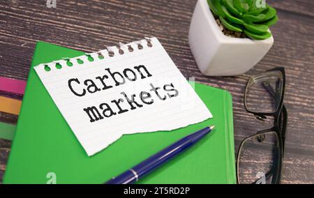 CARBON MARKETS. text on white paper near dollar bills Stock Photo