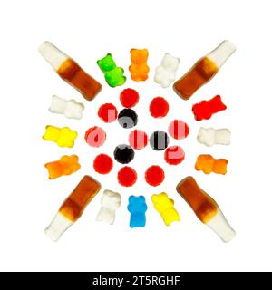 Mix of multi-colored jelly candies in the form of bears, bottles of cola, berries on a white background, top view. Stock Photo