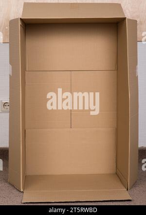 Inside view of empty open cardboard box. Packing for cargo. Moving, new home and cardboard box for packing house furniture, living room staff and apar Stock Photo