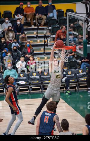 A college Basketball player slams down a dunk Stock Photo