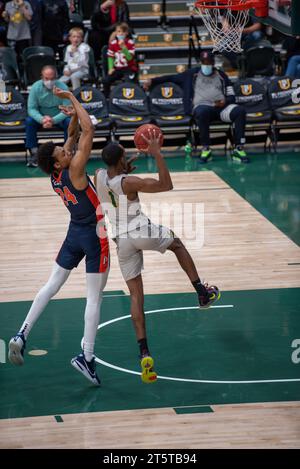 A college basketball player converting a successful layup Stock Photo