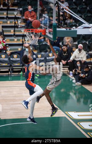 A college basketball player converting a successful layup Stock Photo