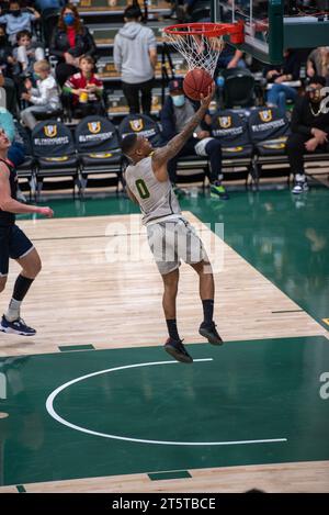 A college basketball player converting a successful layup Stock Photo