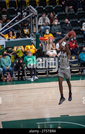 A college Basketball player slams down a dunk Stock Photo