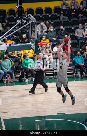 A college Basketball player slams down a dunk Stock Photo