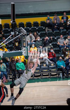 A college Basketball player slams down a dunk Stock Photo