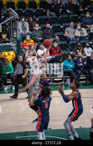 A college Basketball player slams down a dunk Stock Photo