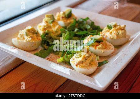 Deviled Eggs Topped with Avocado Appetizer Stock Photo
