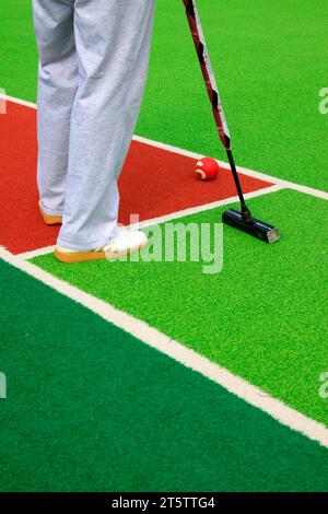 Chinese gate ball ball arm and athlete's legs, closeup of photo Stock Photo