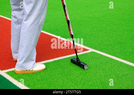 Chinese gate ball ball arm and athlete's legs, closeup of photo Stock Photo