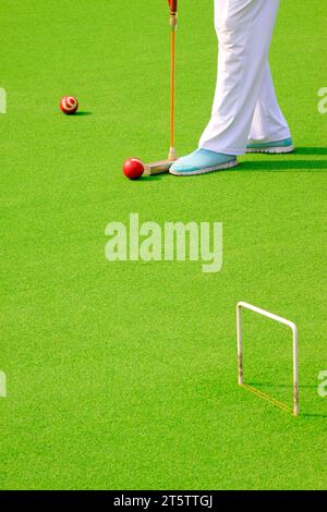 Chinese gate ball ball arm and athlete's legs, closeup of photo Stock Photo