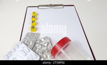 Single Word 'INPS' On Wooden Block. Taxes concept Italian government reform. Notebook on the table with medicines. Stock Photo