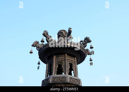 Wind chimes on incense burner Stock Photo