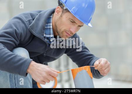 man digging out clogged sewer line closeup Stock Photo