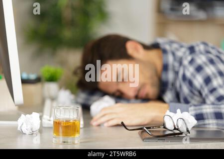 young businessman sleeping after drinking from stress Stock Photo