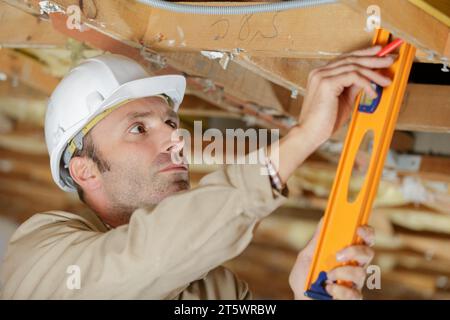 construction worker thermally insulating eco wooden frame house Stock Photo