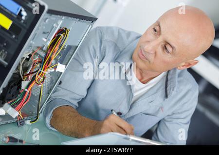 expert man assembling pc and checking for problem Stock Photo