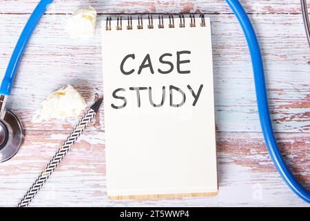Case study the text is written on a notebook that lies on old vintage boards Stock Photo