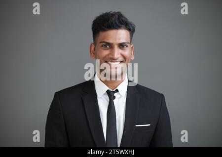 Studio portrait of smiling Indian entrepreneur in formal suit Stock Photo