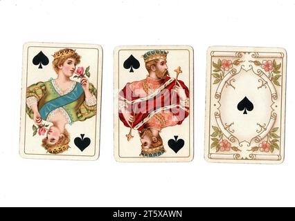 Three antique playing cards showing a queen, king and ace of spades on a white background. Stock Photo