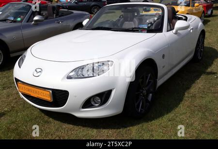 Three-quarters Front View of a White, Mazda MX-5 (NC - 3rd Generation),on display in the MX-5 Owners Club zone of the 2023 British Motor Show . Stock Photo