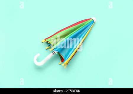 Mini colorful umbrella on green background Stock Photo