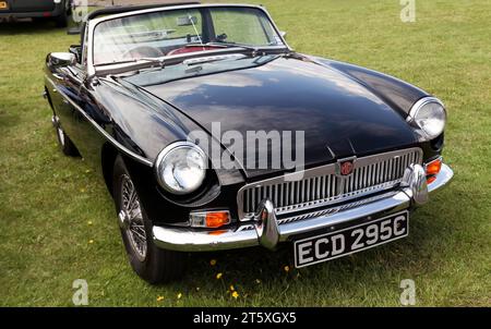 Three-quarters front view of a 1965, Black,  MGB roadster, on display at the 2023 British Motor Show Stock Photo