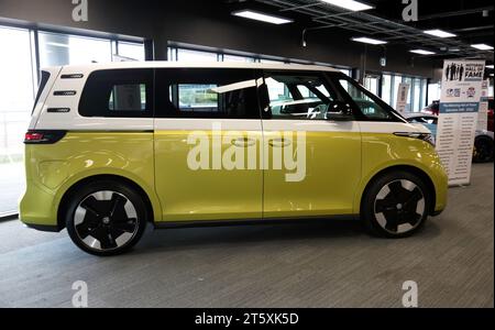 Side view of a 2022, Candy White and Lime Yellow,  VW ID Buzz,  battery electric minivan, voted overall best car of 2023. Stock Photo