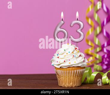 Birthday Cake With Candle Number 63 - On Pink Background. Stock Photo