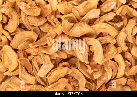 Dried apples or apple chips as an abstract background. Close up. Stock Photo