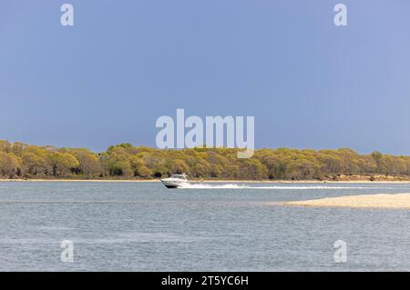 large white power boat underway off shelter island on a summer day Stock Photo