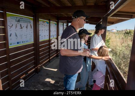 A family look out from the Voroklini lake bird hide, Larnca, Cyprus Stock Photo