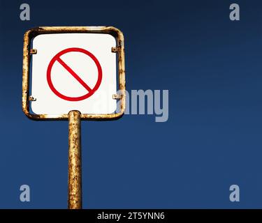 rusty blank prohibite sign on pole Stock Photo