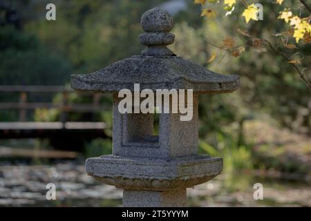 Stone Japanese lantern in the autumn day in the Japanese garden. Main Botanical garden of the Academy of Sciences of Russia Stock Photo