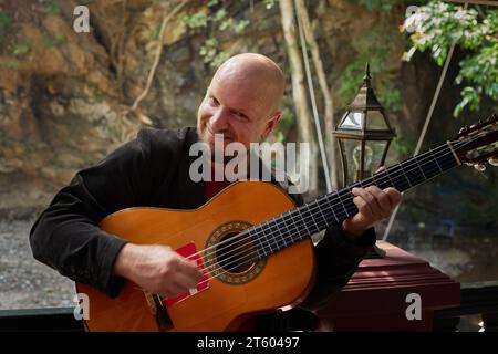 Man playing the guitar with passion and skill in the great outdoors Stock Photo