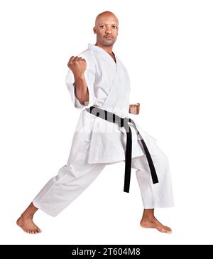 african american karate man in a kumite stance, exercising his kata, in white kimono uniform with belt Stock Photo